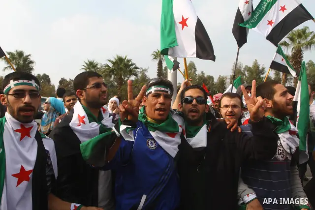 Pro-reform supporters protest outside the Arab League headquarters in the Egyptian capital Cairo, where a ministerial meeting on Syria was held on November 24, 2011. Arab foreign ministers have invited Syria to sign an a...