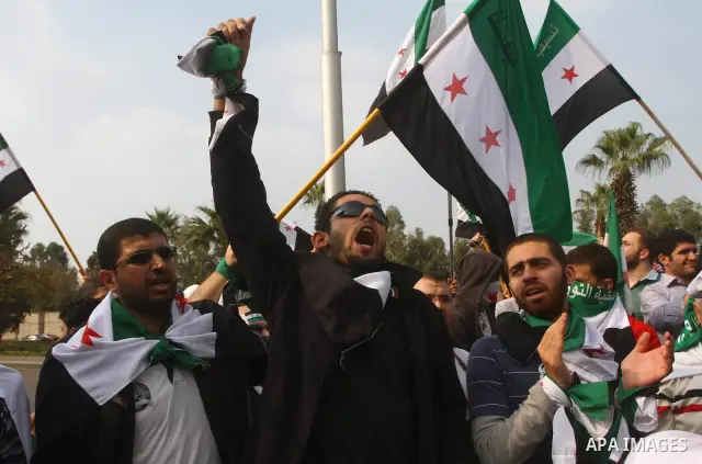 Pro-reform supporters protest outside the Arab League headquarters in the Egyptian capital Cairo, where a ministerial meeting on Syria was held on November 24, 2011. Arab foreign ministers have invited Syria to sign an a...