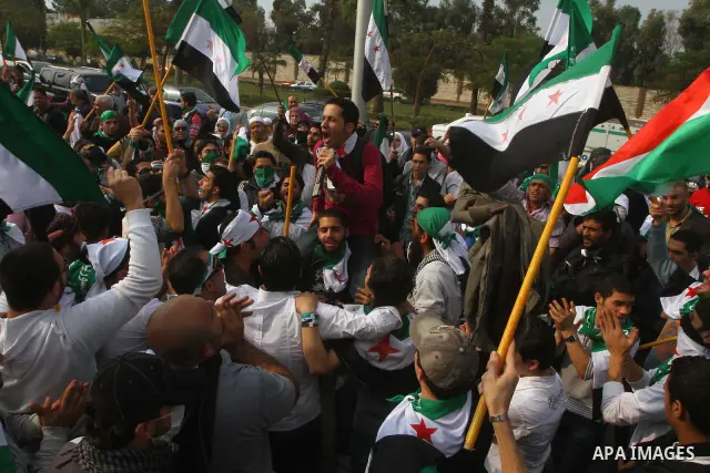 Pro-reform supporters protest outside the Arab League headquarters in the Egyptian capital Cairo, where a ministerial meeting on Syria was held on November 24, 2011. Arab foreign ministers have invited Syria to sign an a...