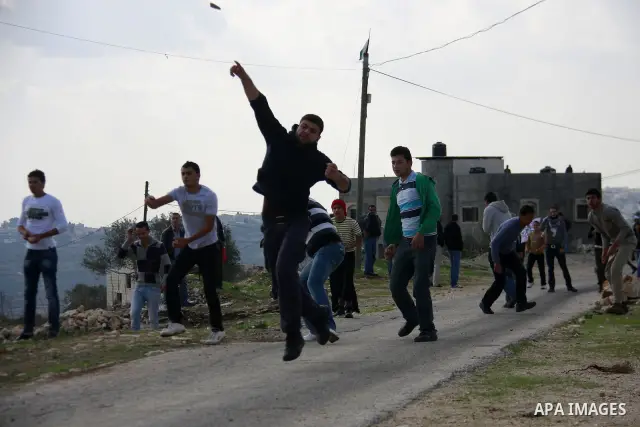 Palestinian protesters clash with Israeli soldiers during a protest near Kufr Qaddum, near the northern West Bank Jewish settlement of Kdumim Friday, Nov. 25, 2011. The protest was held against the closure of a main road...