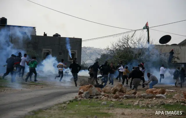 Palestinian protesters clash with Israeli soldiers during a protest near Kufr Qaddum, near the northern West Bank Jewish settlement of Kdumim Friday, Nov. 25, 2011. The protest was held against the closure of a main road...