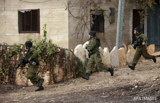 Israeli soldiers clash with Palestinian protesters during a protest near Kufr Qaddum, near the northern West Bank Jewish settlement of Kdumim Friday, Nov. 25, 2011. The protest was held against the closure of a main road...
