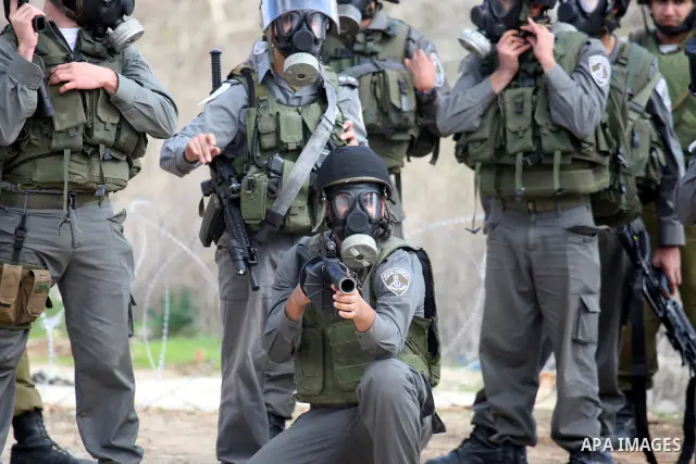 Israeli soldiers clash with Palestinian protesters during a protest near Kufr Qaddum, near the northern West Bank Jewish settlement of Kdumim Friday, Nov. 25, 2011. The protest was held against the closure of a main road...