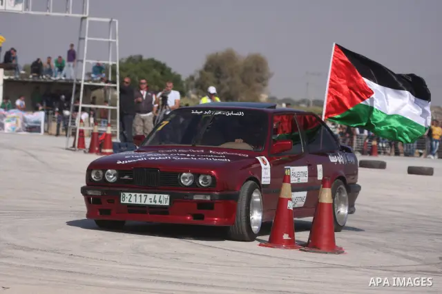 A driver competes with his car during a car rally in the West Bank city of Jericho November 25, 2011. Some 50 drivers from the Palestinian Territories and Jordan competed on Friday in the final round of the Palestinian c...