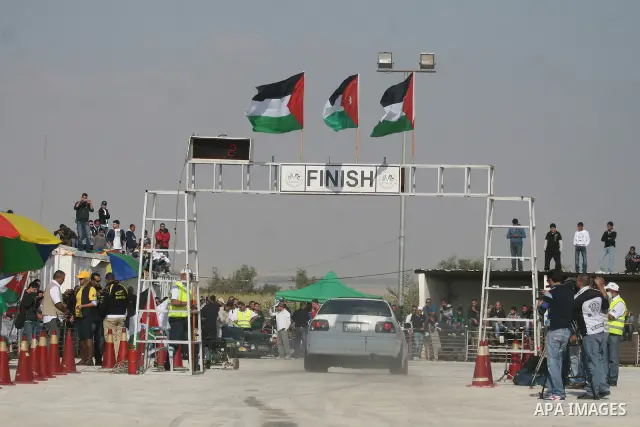 A driver competes with his car during a car rally in the West Bank city of Jericho November 25, 2011. Some 50 drivers from the Palestinian Territories and Jordan competed on Friday in the final round of the Palestinian c...