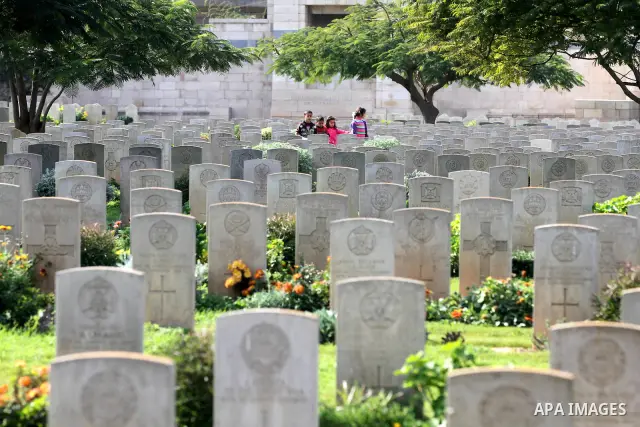 Palestinian children are seen in the British cemetery in Gaza City on Nov 26, 2011. Israel said it would compensate British for damages that hit the British cemetery during the war on Gaza. Photo by Majdi Fathi