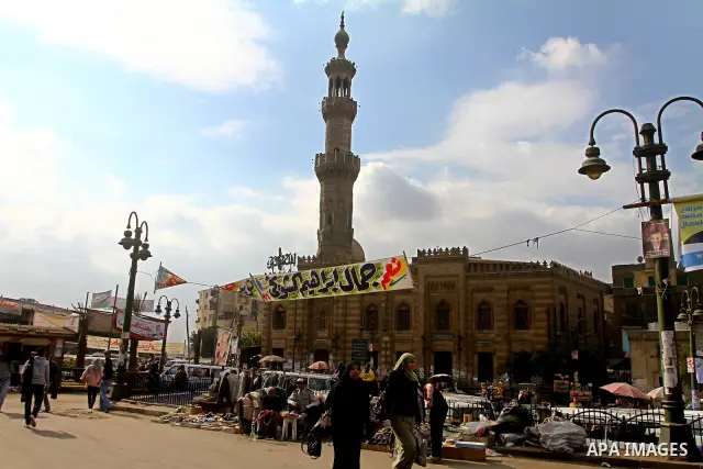 Egyptians walk past electoral campaign posters and banners for candidates in Cairo on November 27, 2011 on the eve of the first parliament elections since the end of the 30-year rule of strongman Hosni Mubarak. Photo by...