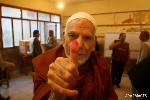 An Egyptian man shows his ink-stained thumb after casting his vote at a polling station in the Manial neighbourhood of Cairo on November 28, 2011. Egyptians began voting in the first elections since the fall of autocrat...