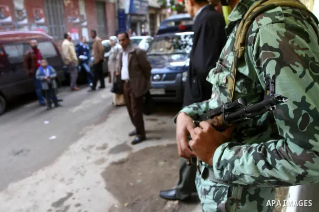 An Egyptian soldier stands guard as voters queue at a polling station in the Manial neighbourhood of Cairo on November 28, 2011. Egyptians began voting in the first elections since the fall of autocrat Hosni Mubarak who...