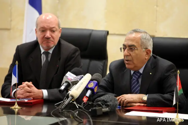 Palestinian Prime Minister, Salam Fayyad and French Consul-General, Frederick Dzanao attend the signing of grant agreement from the French government with 10 million euros in support of the budget of the National Authori...