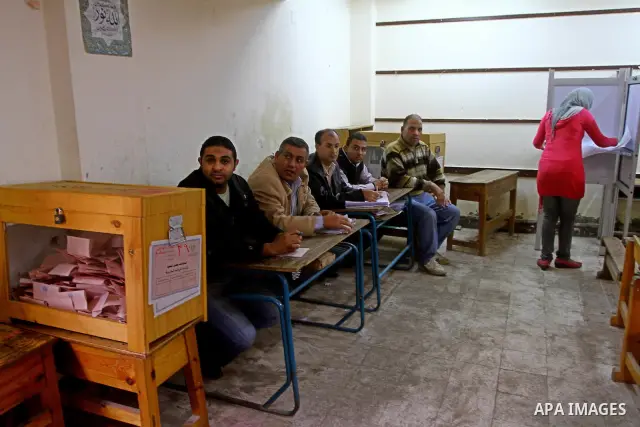 Egyptians cast their ballot at a parliamentary polling station in Cairo on November 29, 2011. Egypt hailed the start of its first post-revolution election as a triumph for democracy as more voters headed to the polls, bo...