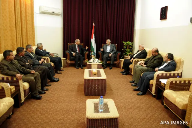 Palestinian prime minister in Gaza Strip, Ismail haniya attends a meeting with a delegation from the Democratic Front for Liberation Palestine at his office, in Gaza city on Nov. 30,2011. Photo by Ahmed Shaat
