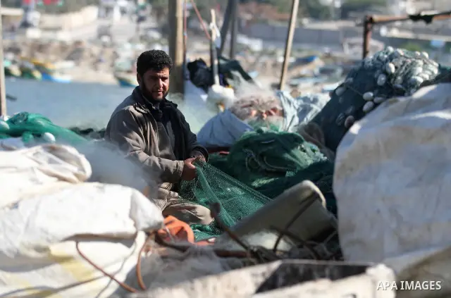 A Palestinian fisherman works at the port in Gaza City on December 01, 2011. Before the Israeli embargo on the Palestinian territory, some 3,500 fishermen plied their trade off Gaza's 40-kilometre (25-mile) Mediterranean...