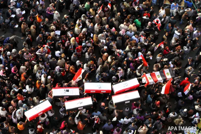 Egyptian protesters carry symbolic coffins honoring those killed in recent clashes with security forces during a rally in Tahrir Square, in Cairo, Egypt, Friday, Dec. 2, 2011. Islamists appear to have taken a strong majo...