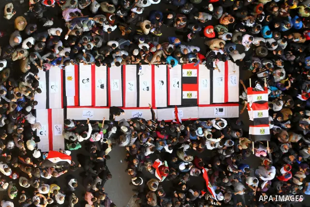 Egyptian protesters carry symbolic coffins honoring those killed in recent clashes with security forces during a rally in Tahrir Square, in Cairo, Egypt, Friday, Dec. 2, 2011. Islamists appear to have taken a strong majo...