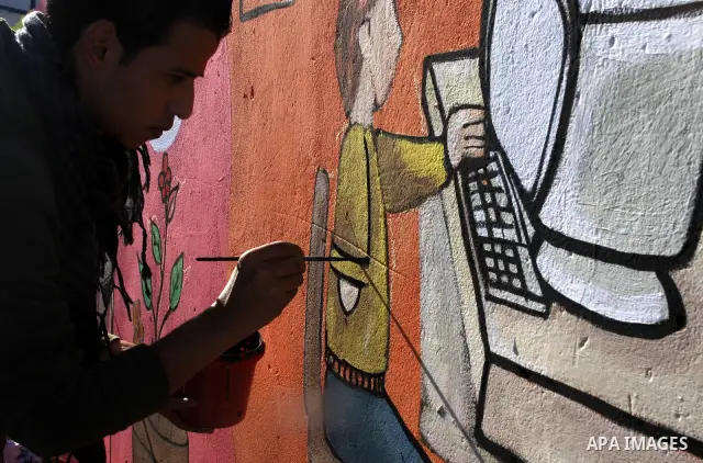 Palestinian Artists take part in paint a murals to mark the International Day for Persons with Disabilities on Dec. 03, 2011 in Gaza City.Photo by Mahmud Nassar