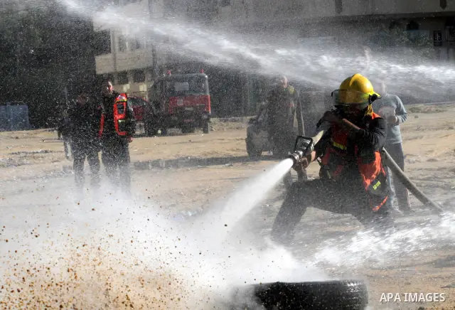 Members of the Palestinian civil defence demonstrate thier skills during a training session following the campaign "your Safety", in Gaza city on Dec. 04, 2011. Photo by Mohammed Asad