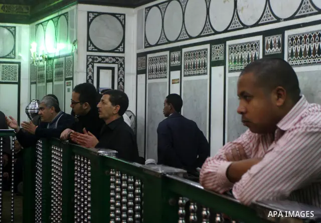 Egyptian Muslims pray at a tomb in al-Hussein mosque, which according to the belief head of Imam Hussein, the grandson of prophet Mohammed, is buried, in the old city of Cairo on December 4, 2011. Photo by Ashraf Amra