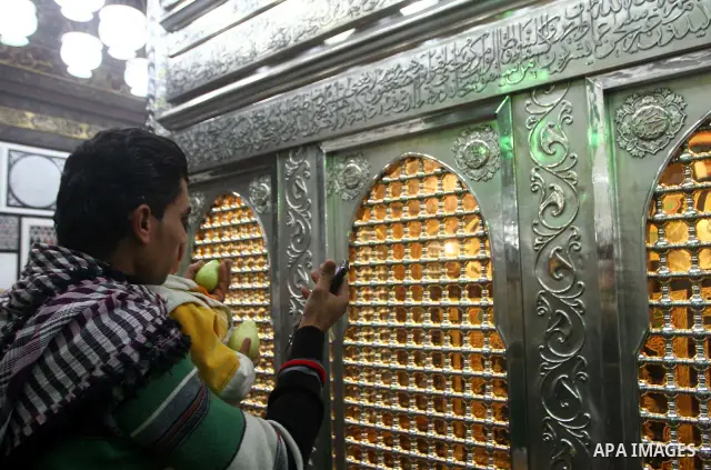Egyptian Muslims pray at a tomb in al-Hussein mosque, which according to the belief head of Imam Hussein, the grandson of prophet Mohammed, is buried, in the old city of Cairo on December 4, 2011. Photo by Ashraf Amra