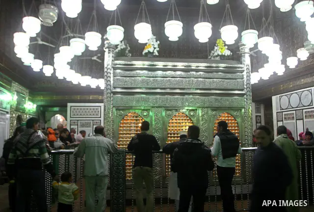 Egyptian Muslims pray at a tomb in al-Hussein mosque, which according to the belief head of Imam Hussein, the grandson of prophet Mohammed, is buried, in the old city of Cairo on December 4, 2011. Photo by Ashraf Amra