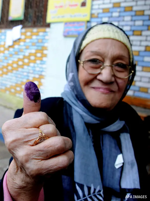 Egyptians cast their ballot at a parliamentary polling station in the run-off of the first round of voting in the Cairo neighbourhood of Bab El-Shaeria on December 5, 2011. Islamist candidates in Egypt looked to extend t...