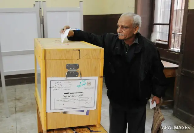 Egyptians cast their ballot at a parliamentary polling station in the run-off of the first round of voting in the Cairo neighbourhood of Bab El-Shaeria on December 5, 2011. Islamist candidates in Egypt looked to extend t...