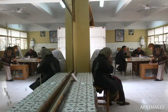 An Egyptian woman votes at a polling center during the first day of runoffs in Cairo, Egypt, Monday, Dec. 5, 2011. A trickle of Egyptian voters headed to the polls Monday for two days of runoffs in the country's first pa...