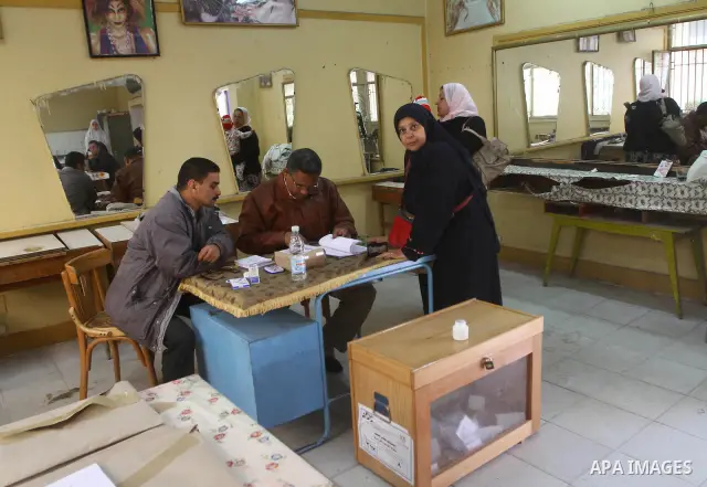 An Egyptian woman votes at a polling center during the first day of runoffs in Cairo, Egypt, Monday, Dec. 5, 2011. A trickle of Egyptian voters headed to the polls Monday for two days of runoffs in the country's first pa...