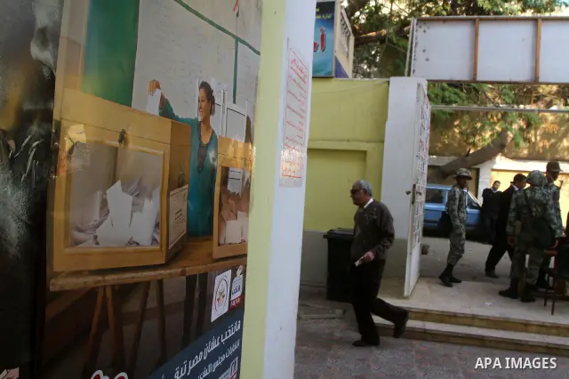 An Egyptian woman votes at a polling center during the first day of runoffs in Cairo, Egypt, Monday, Dec. 5, 2011. A trickle of Egyptian voters headed to the polls Monday for two days of runoffs in the country's first pa...