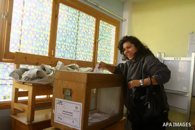 An Egyptian woman votes at a polling center during the first day of runoffs in Cairo, Egypt, Monday, Dec. 5, 2011. A trickle of Egyptian voters headed to the polls Monday for two days of runoffs in the country's first pa...