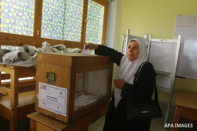 An Egyptian woman votes at a polling center during the first day of runoffs in Cairo, Egypt, Monday, Dec. 5, 2011. A trickle of Egyptian voters headed to the polls Monday for two days of runoffs in the country's first pa...