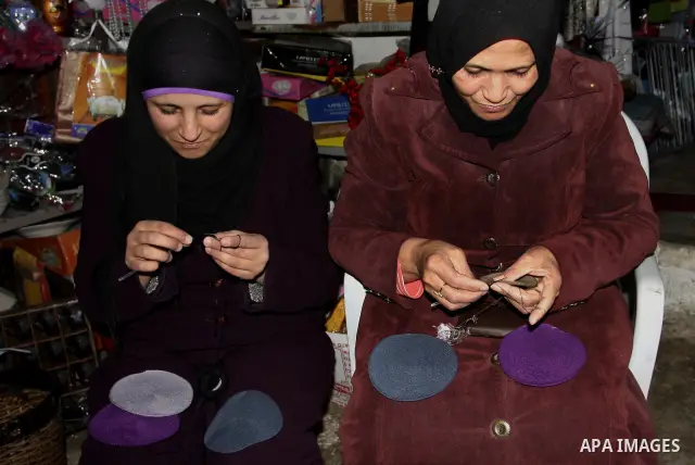 Palestinian women knit Kippas, traditional Jewish skullcaps, in the West Bank Village of Brukin near Nablus, Sunday, Dec. 05, 2011. The Palestinian women knit the Kippas in their West Bank village in order to sell them t...