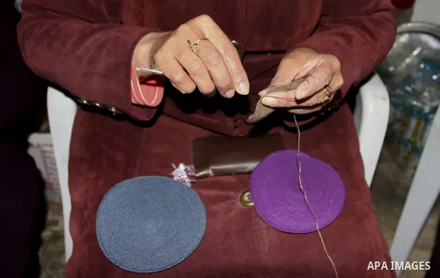 Palestinian women knit Kippas, traditional Jewish skullcaps, in the West Bank Village of Brukin near Nablus, Sunday, Dec. 05, 2011. The Palestinian women knit the Kippas in their West Bank village in order to sell them t...