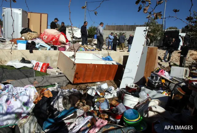 Palestinian men react after Israeli forces destroyed their family house in an area of the east Jerusalem neighborhood of Beit Hanina which falls in the West Bank side of Israel's separation barrier on Dec. 5, 2011. Accor...