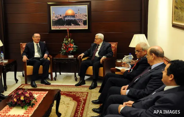 Palestinian President Mahmoud Abbas sits near the U.S. Assistant Secretary of State for Near East Affairs Jeffrey Feltman before their meeting in the West Bank city of Ramallah December 5, 2011. Photo by Thaer Ganaim