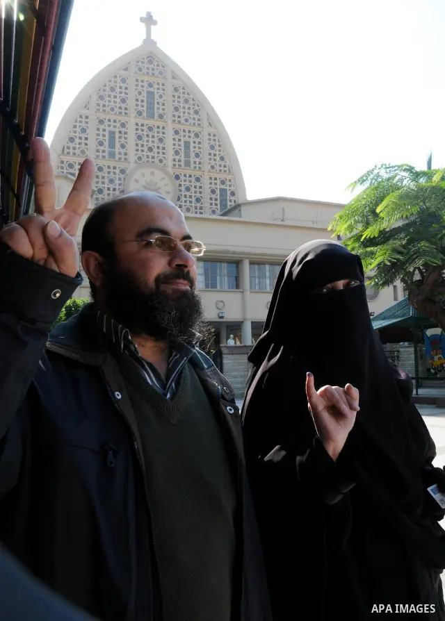 Egyptians cast their ballot at a parliamentary polling station in the run-off of the first round of voting in the Cairo neighbourhood of Bab El-Shaeria on December 5, 2011. Islamist candidates in Egypt looked to extend t...