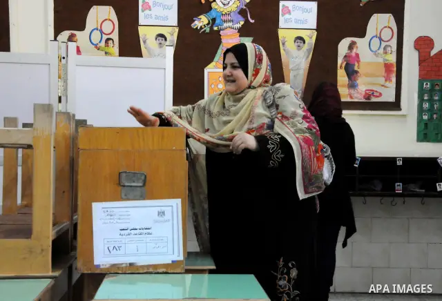 Egyptians cast their ballot at a parliamentary polling station in the run-off of the first round of voting in the Cairo neighbourhood of Bab El-Shaeria on December 5, 2011. Islamist candidates in Egypt looked to extend t...