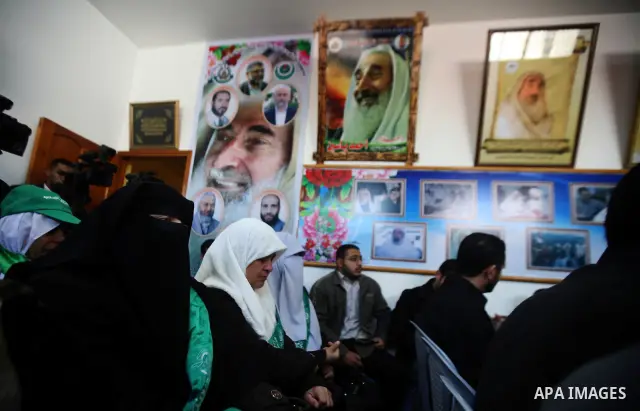 Palestinian Hamas supporters gather at the Hamas founder home, Ahmed Yaseen to announce the starting of the launch of celebrations marking the 24th anniversary of the Islamist movement's foundation, in Gaza City on Dec 5...