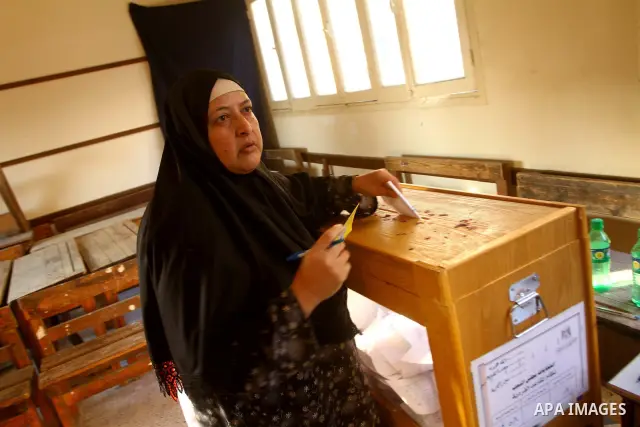 Egyptians cast their ballot at a parliamentary polling station in the run-off of the first round of voting in the Cairo on December 5, 2011. Islamist candidates in Egypt looked to extend their crushing victory in the cou...
