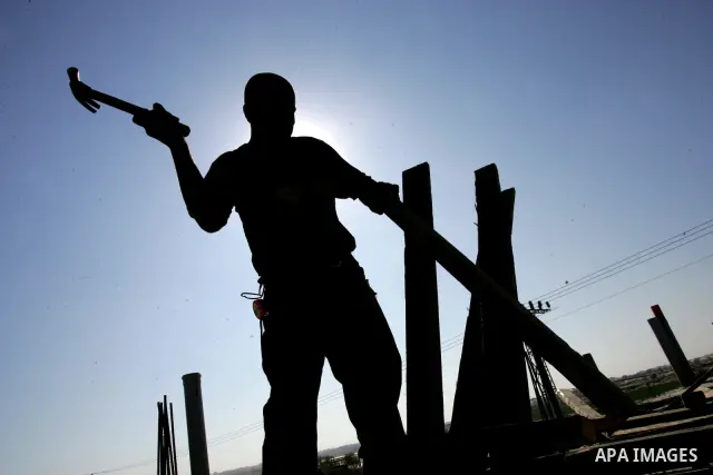 Palestinian laborours work to construct new houses in a project funded by the United Nations Relief and Works Agency for Palestine Refugees (UNRWA) in Rafah, in the southern of Gaza Strip on December 5, 2011. Israel main...