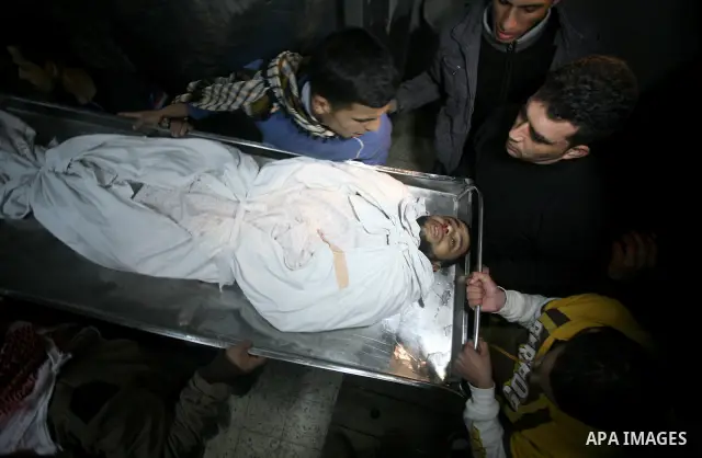 Palestinians people mourn around the body of Islamic Jihad militant Ismail al-Areer who was killed in an Israeli air strike in Gaza City, Gaza, on 07 December 2011. Photo by Mhmoud Nassar