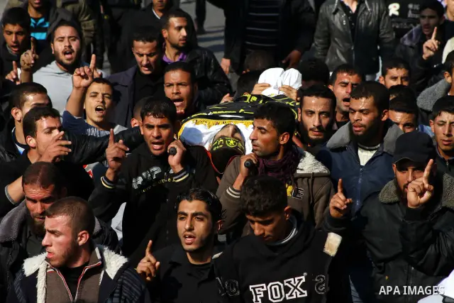 Palestinian mourners carry the body of Islamic Jihad militant Ismail Al-Areer during his funeral in Gaza City on December 7, 2011. A Palestinian was killed and five others were wounded by Israeli air strikes on the Gaza...