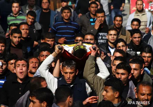 Palestinian mourners carry the body of Islamic Jihad militant Ismail Al-Areer during his funeral in Gaza City on December 7, 2011. A Palestinian was killed and five others were wounded by Israeli air strikes on the Gaza...