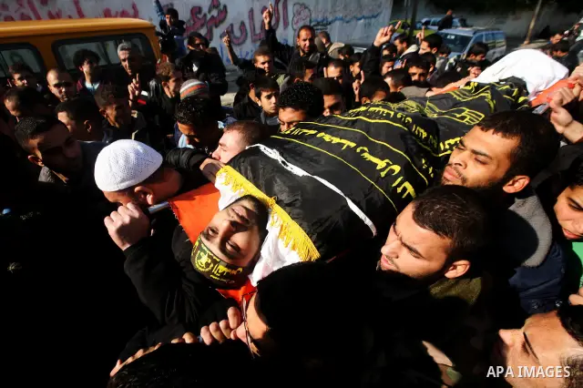 Palestinian mourners carry the body of Islamic Jihad militant Ismail Al-Areer during his funeral in Gaza City on December 7, 2011. A Palestinian was killed and five others were wounded by Israeli air strikes on the Gaza...