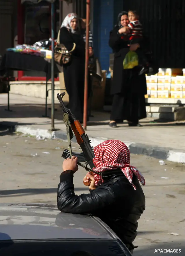 A Palestinian man shots fire in the air during the funeral of Islamic Jihad gunman Ismail Al-Areer in Gaza City December 7, 2011. A Palestinian was killed and five others were wounded by Israeli air strikes on the Gaza S...