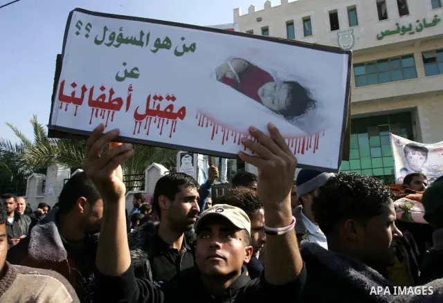 Palestinians protest in front of Khan Yunis Municipality headquarters during the funeral of Wesam,5 years, and his sister Malak Sahloul,3 years, in Khan Younis, southern Gaza Strip on December 7, 2011. Wesam and Malak we...