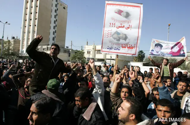 Palestinians protest in front of Khan Yunis Municipality headquarters during the funeral of Wesam,5 years, and his sister Malak Sahloul,3 years, in Khan Younis, southern Gaza Strip on December 7, 2011. Wesam and Malak we...