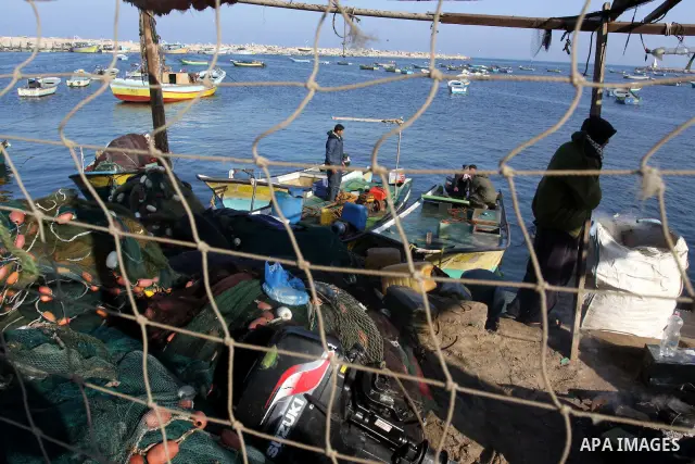 Palestinian fishermen work at a seaport in Gaza on Dec. 8, 2011. Israel is turning Gaza's naval borders into imposed facts by marking the area that Palestinian fishermen are allowed to work in, Hamas authorities said on...