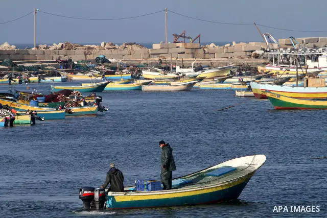 Palestinian fishermen work at a seaport in Gaza on Dec. 8, 2011. Israel is turning Gaza's naval borders into imposed facts by marking the area that Palestinian fishermen are allowed to work in, Hamas authorities said on...