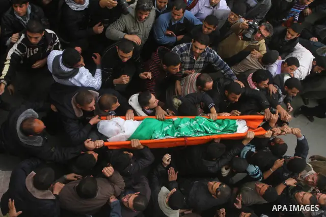 Palestinians carry the bodies of Sobhi al-Batsh, a member of Hamas's armed wing the Ezzedine al-Qassam Brigades, and Issam al-Batsh, a senior member of the Al-Aqsa Martyrs Brigades, mourn outside his home during his fune...